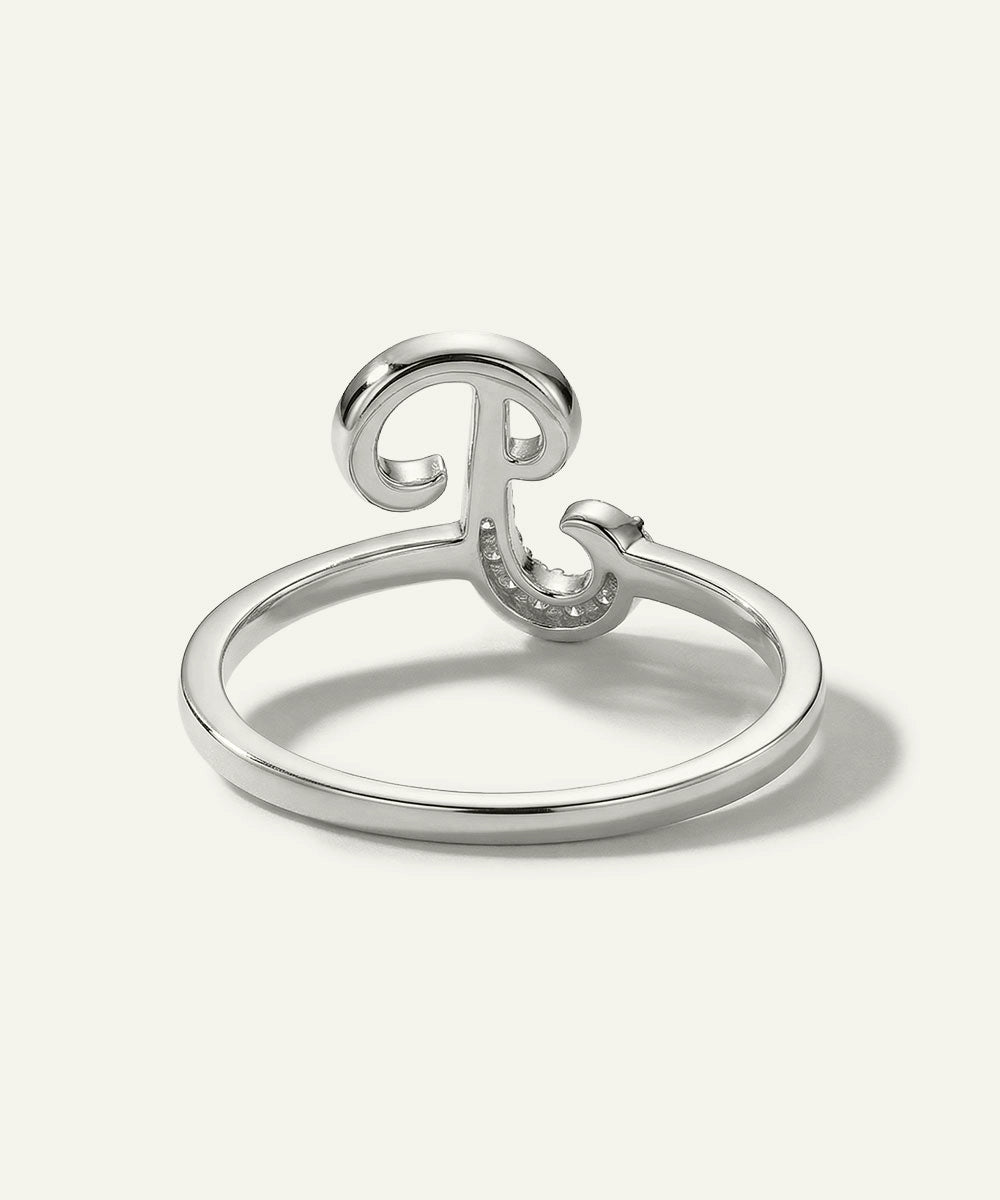 Silver ring with a decorative design on a white background
