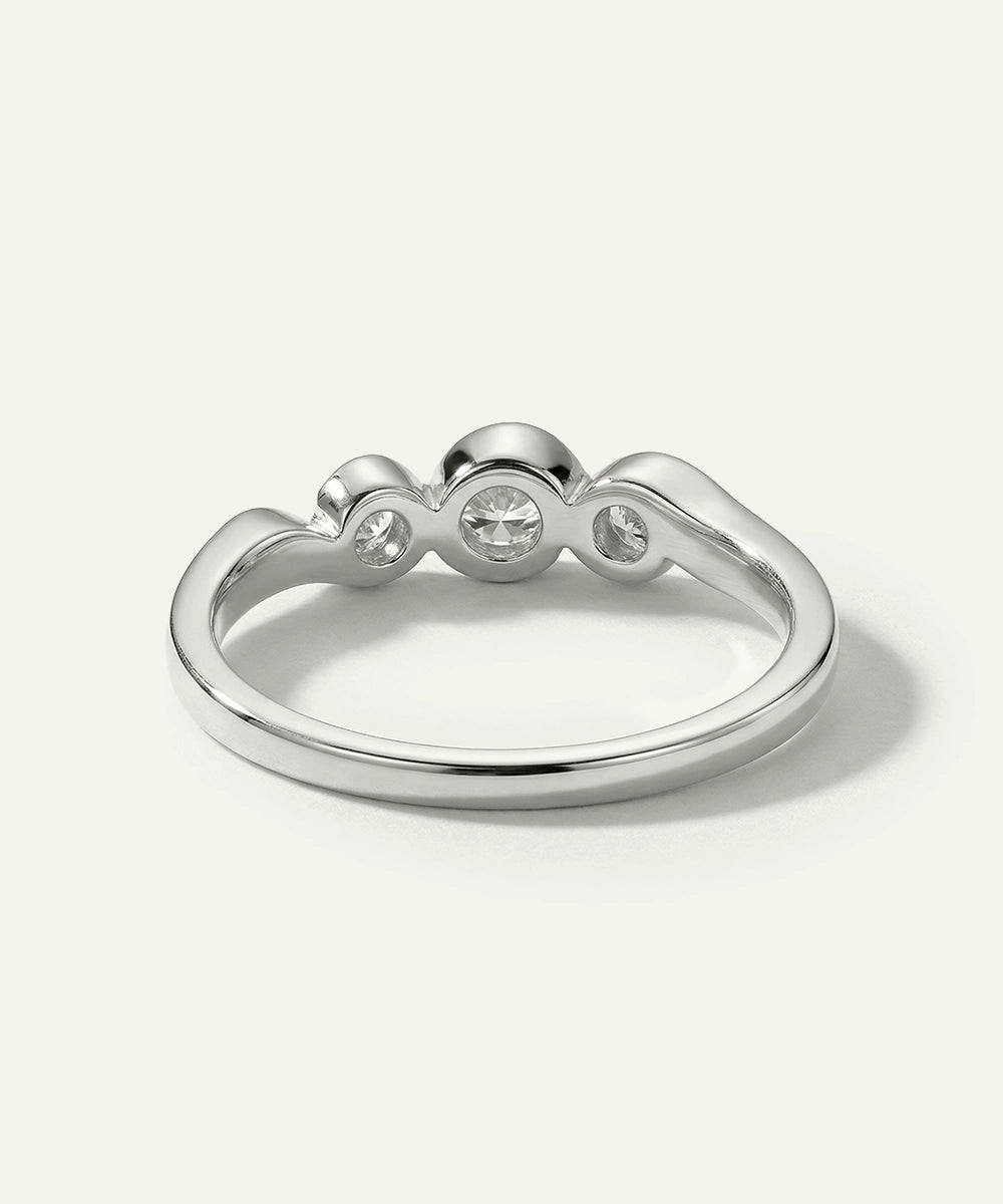 Silver ring with three small diamonds on a white background