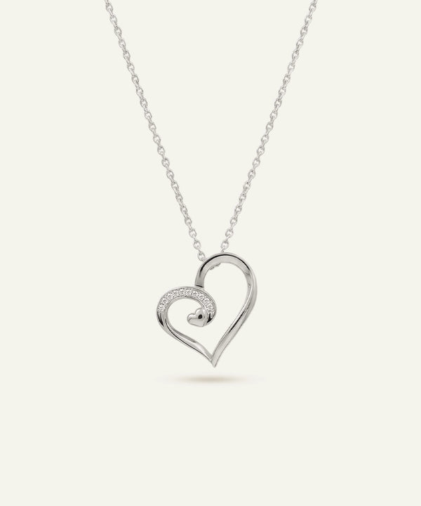 Silver heart-shaped pendant necklace on a white background