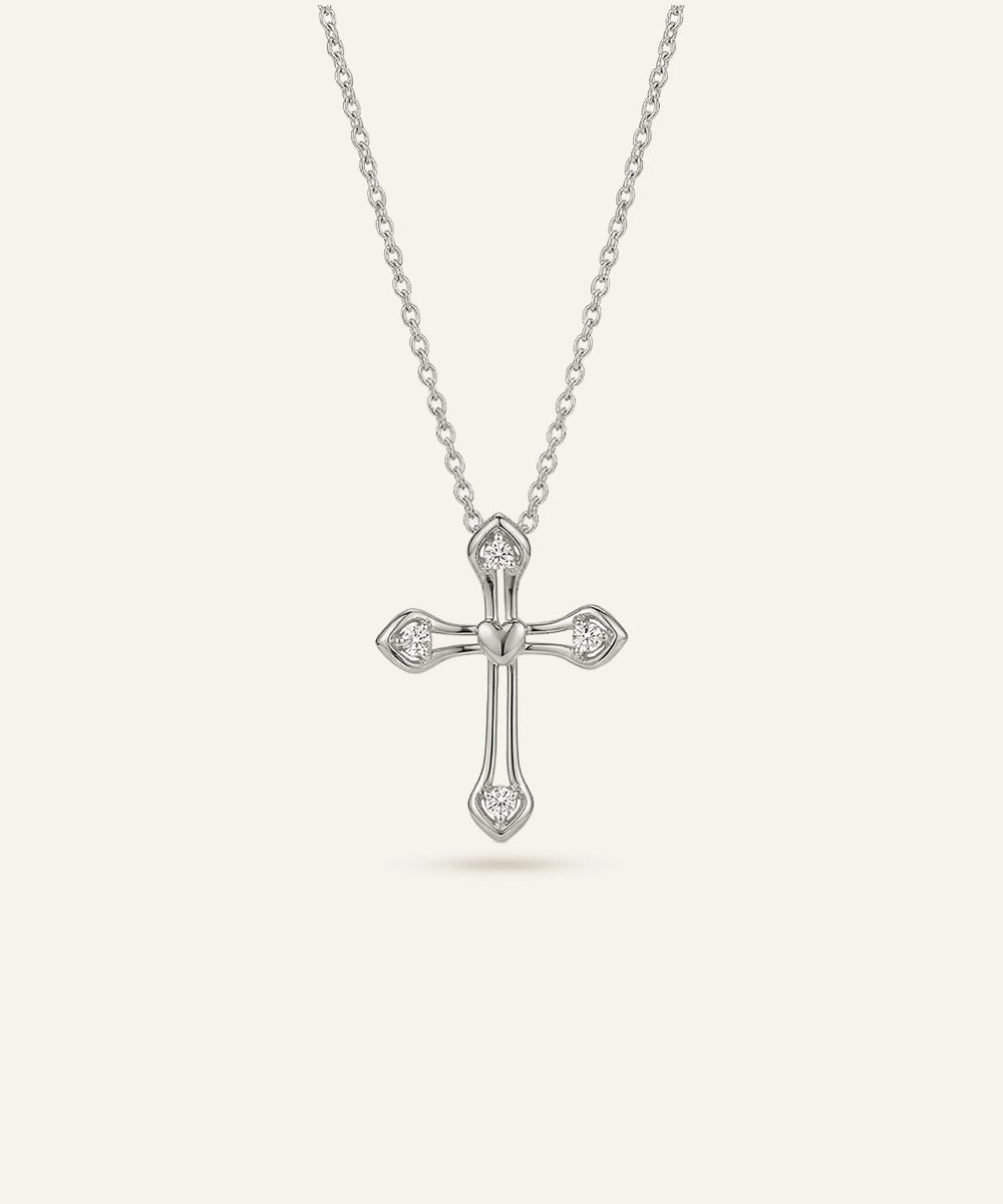 Silver cross necklace with chain on a white background