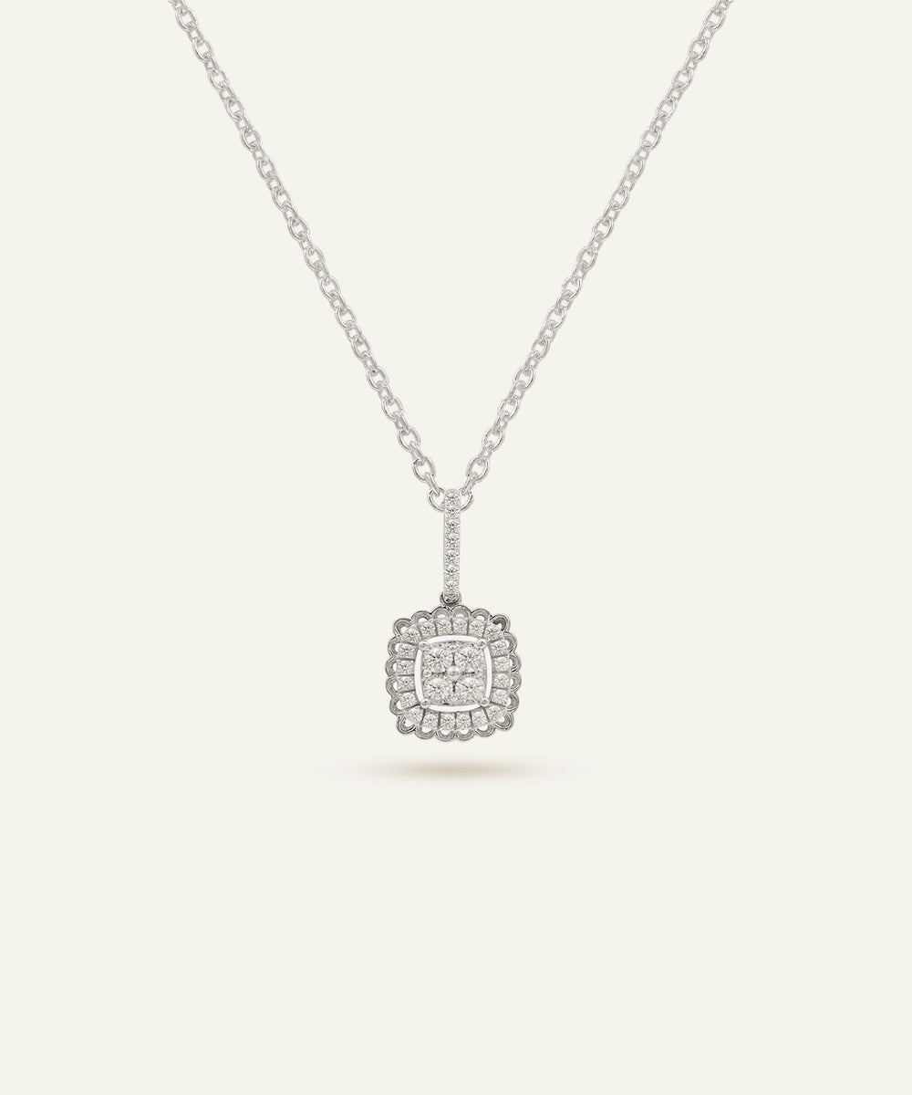 Silver necklace with a square pendant on a light gray background