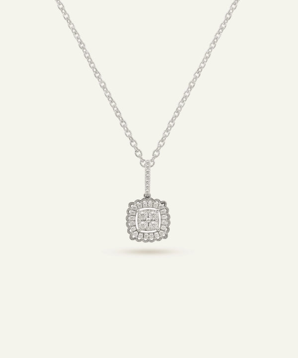 Silver necklace with a square pendant on a light gray background
