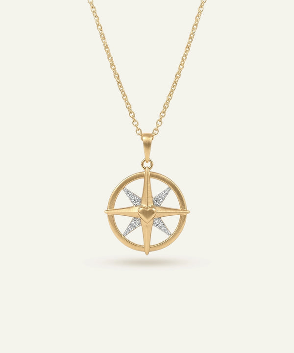 Gold necklace with a star-shaped pendant on a light beige background