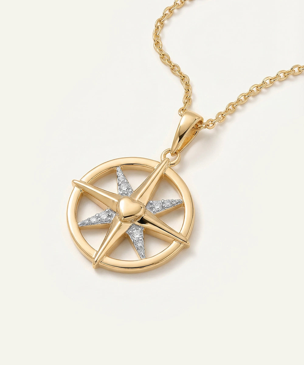 Gold necklace with a star-shaped pendant on a light beige background