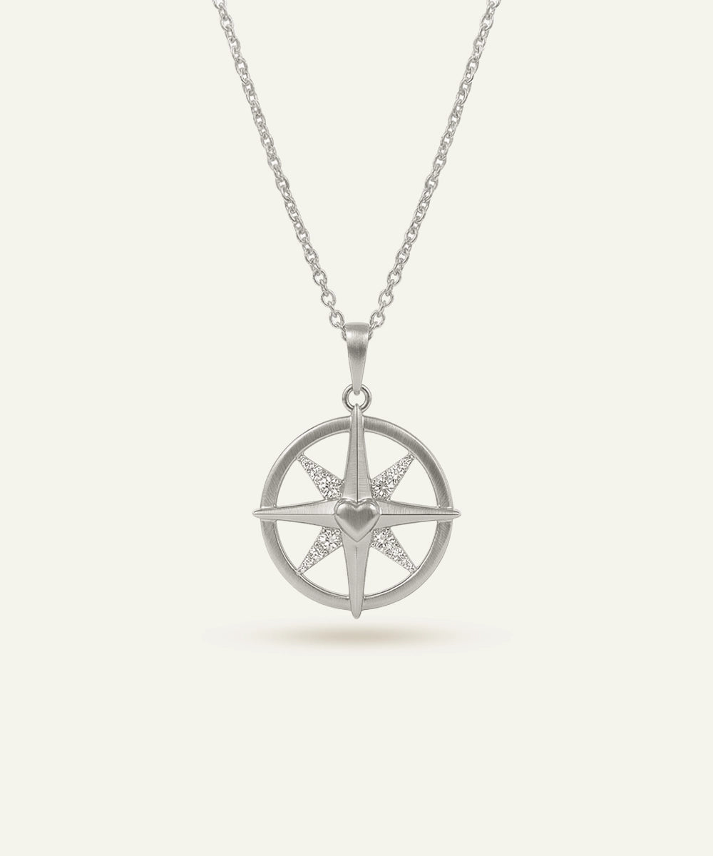 Silver necklace with a star-shaped pendant on a white background