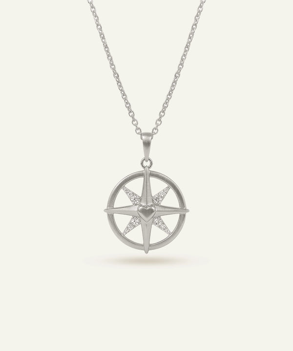 Silver necklace with a star-shaped pendant on a white background