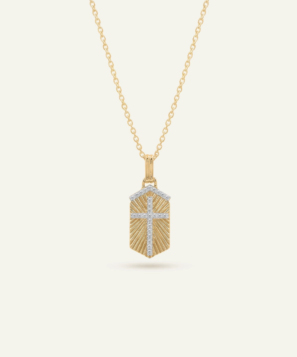 Gold necklace with a geometric pendant on a white background