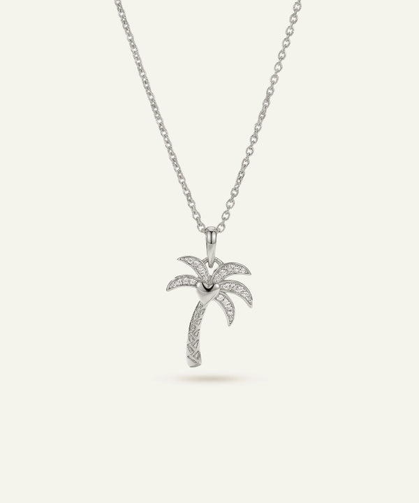 Silver palm tree pendant necklace on a white background