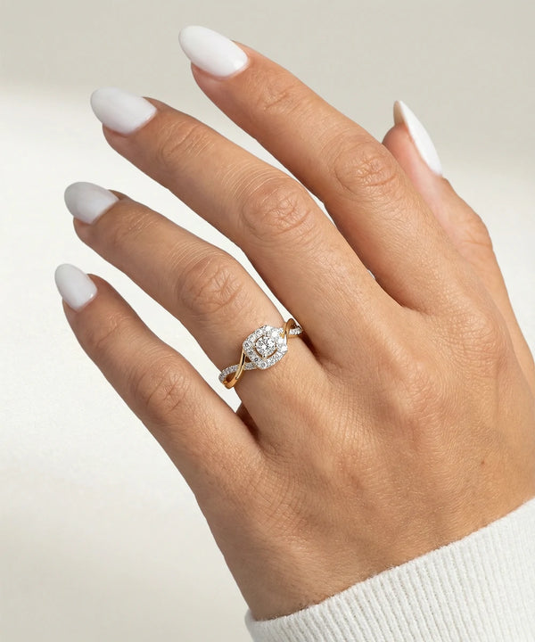 Hand wearing a diamond ring with a neutral background