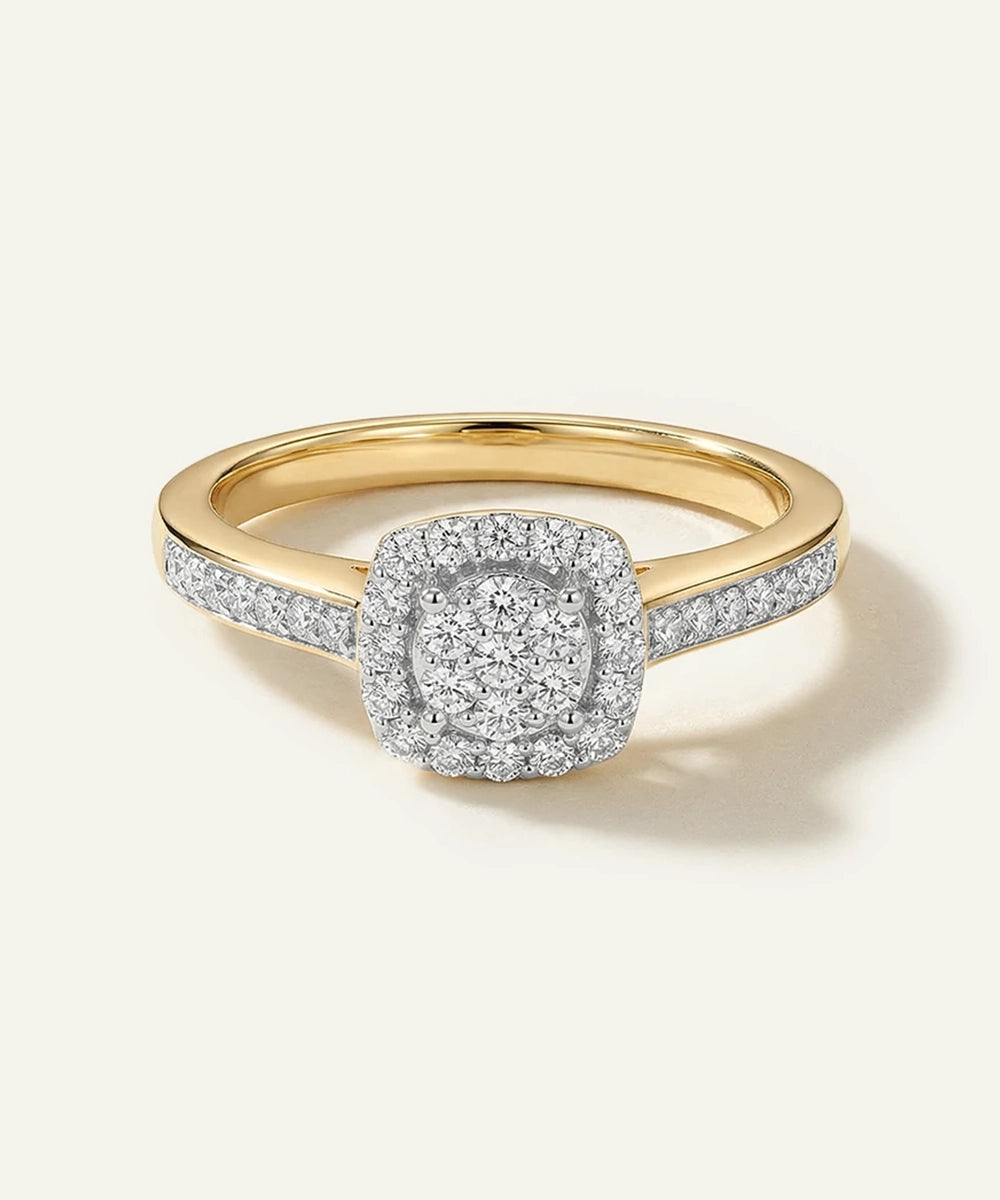 Gold ring with a diamond-studded center on a light beige background