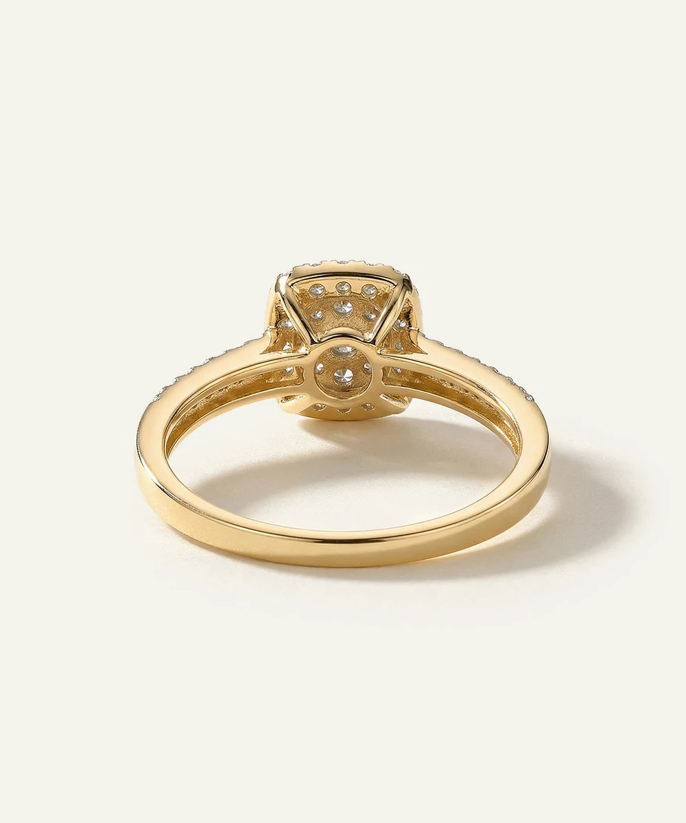 Gold ring with diamond accents on a light beige background