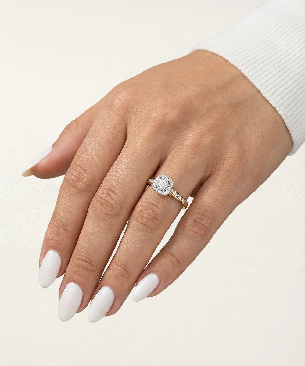 Hand wearing a diamond ring on a light background