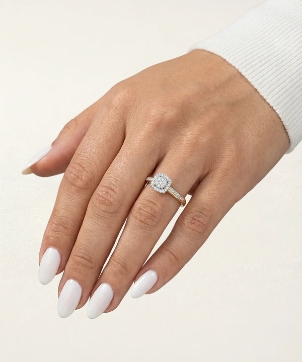 Hand wearing a diamond ring on a light background