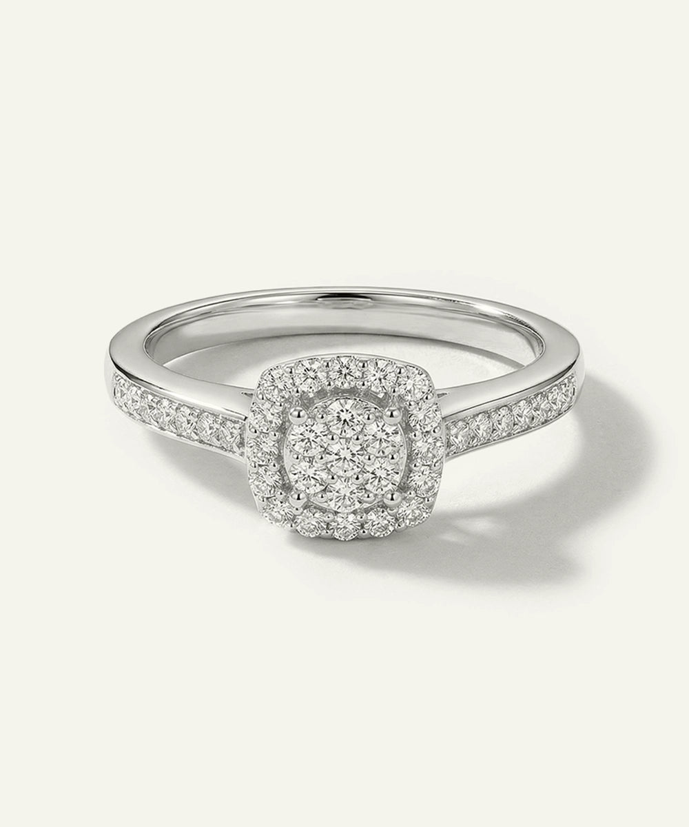 Silver ring with a diamond halo on a white background