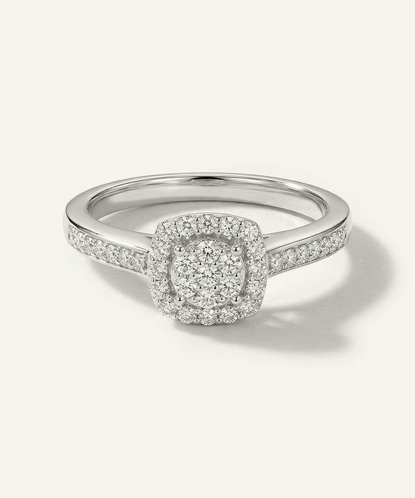 Silver ring with a diamond halo on a white background