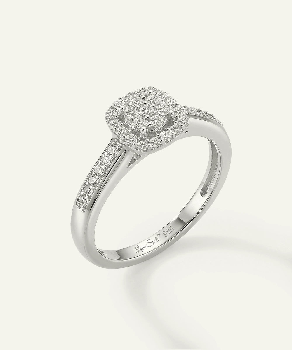 Silver ring with diamond accents on a white background