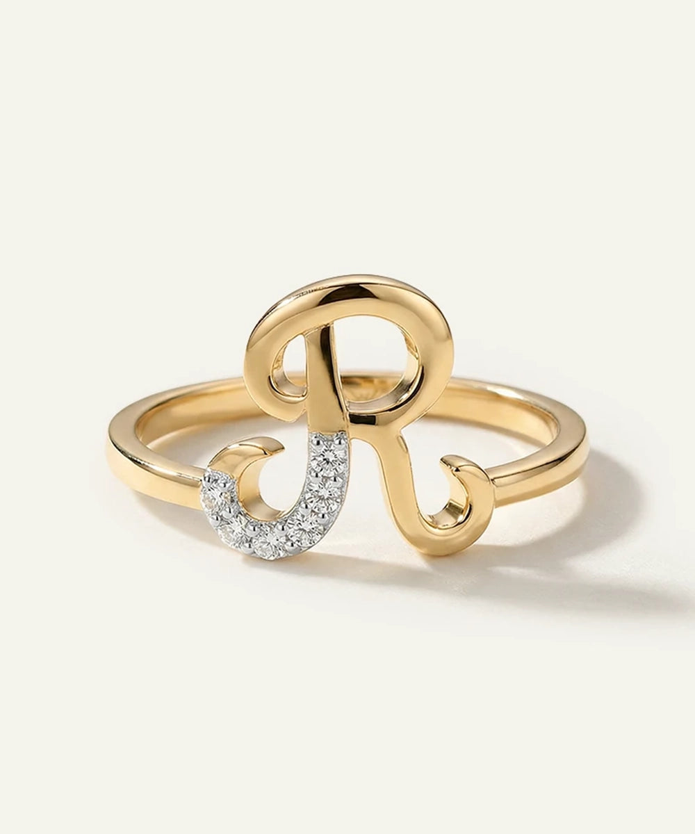 Gold ring with a decorative design on a light background