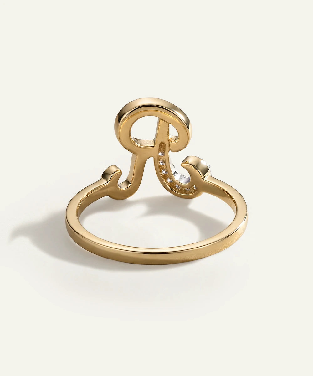 Gold ring with a unique design on a white background