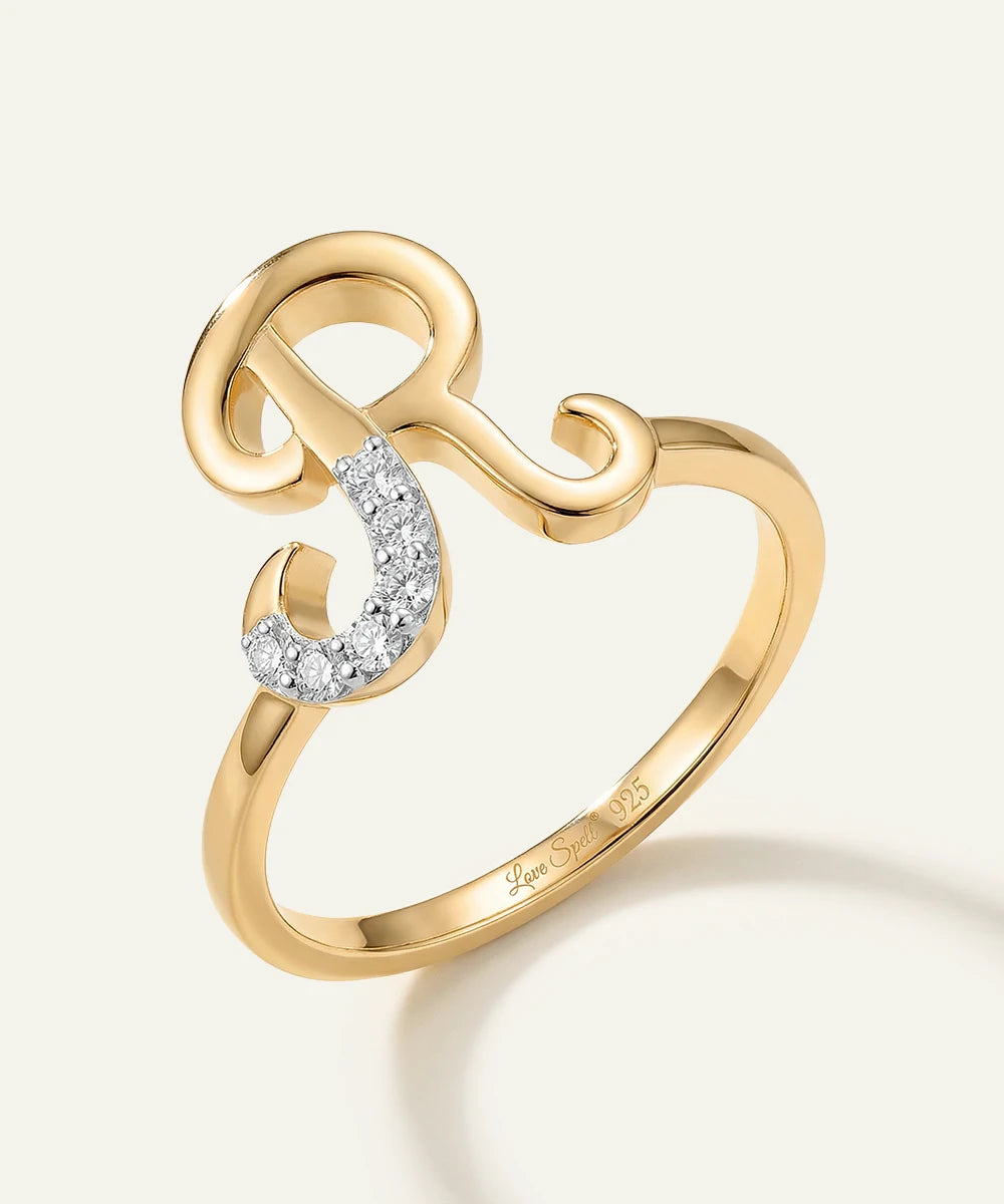 Gold ring with a diamond on a light beige background