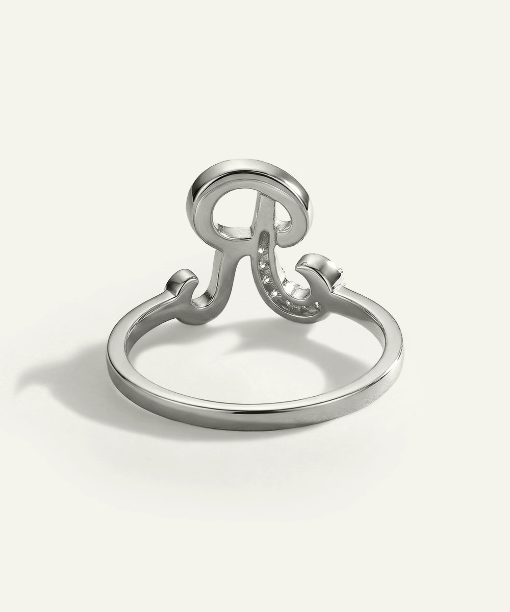Silver ring with a unique design on a white background