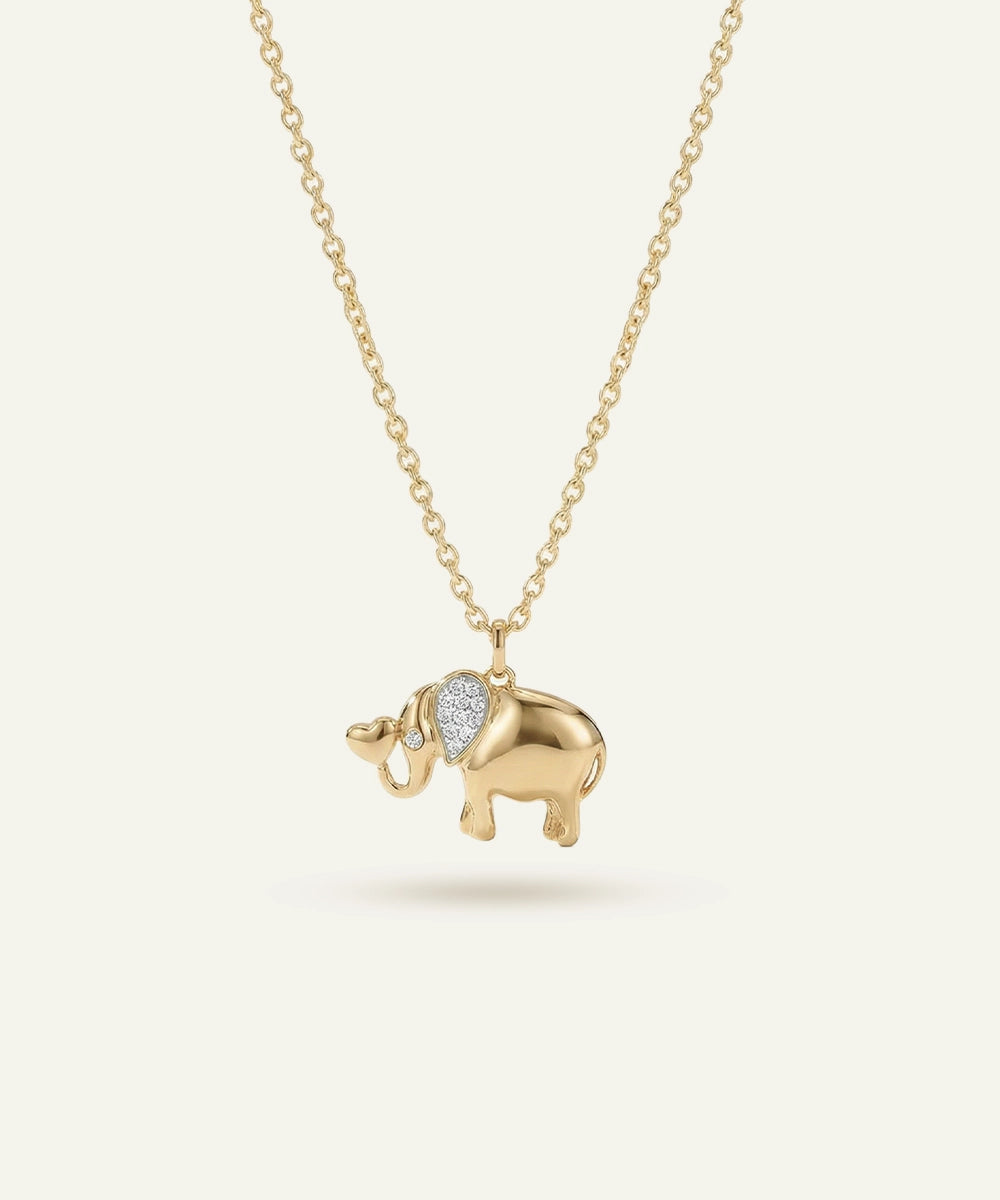 Gold elephant pendant necklace on a white background