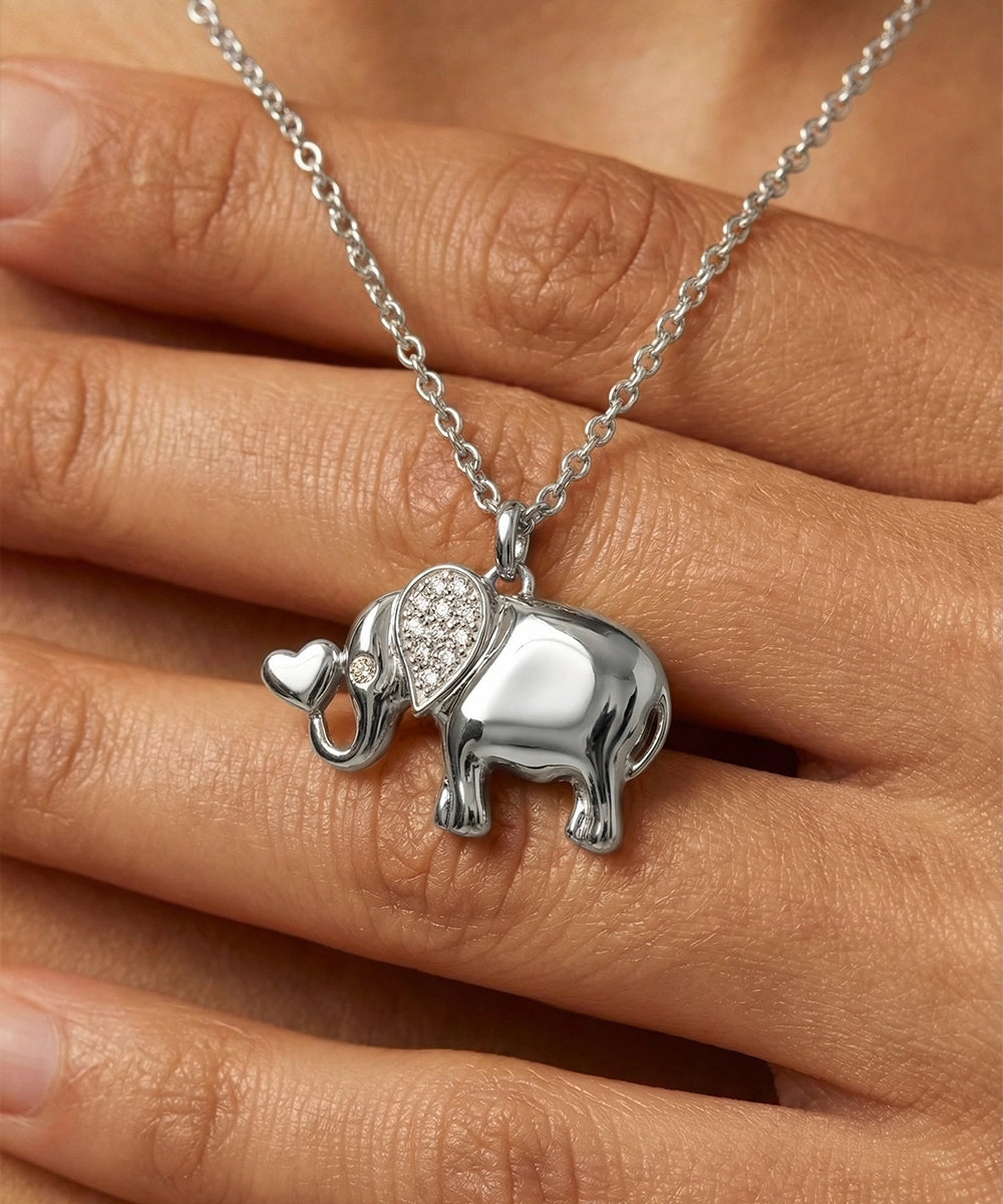 Silver elephant pendant necklace on a hand