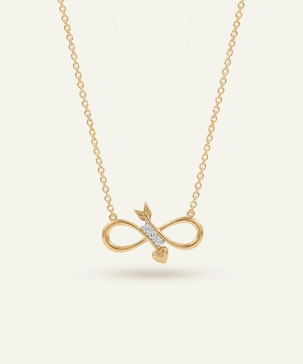 Gold infinity necklace with arrow pendant on a light beige background