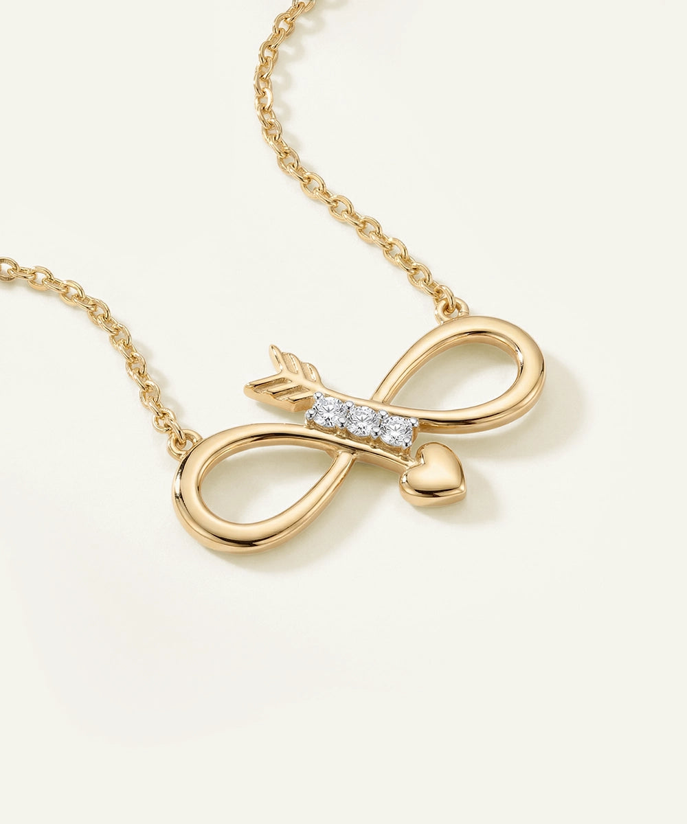 Gold necklace with an infinity symbol pendant on a light background