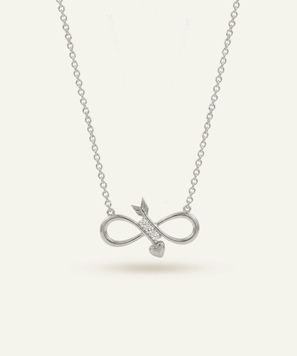 Silver necklace with an infinity symbol pendant on a light gray background