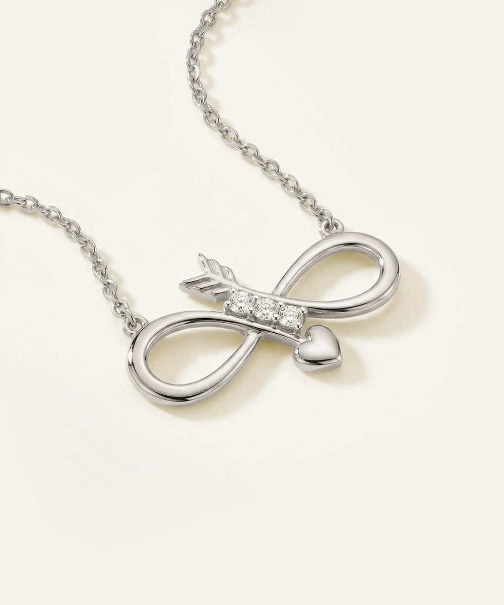 Silver necklace with an infinity symbol pendant on a white background
