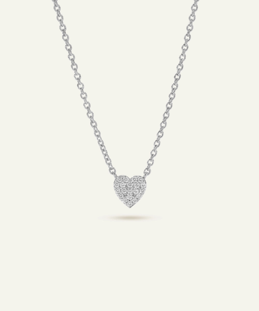 Silver heart-shaped pendant necklace on a light gray background