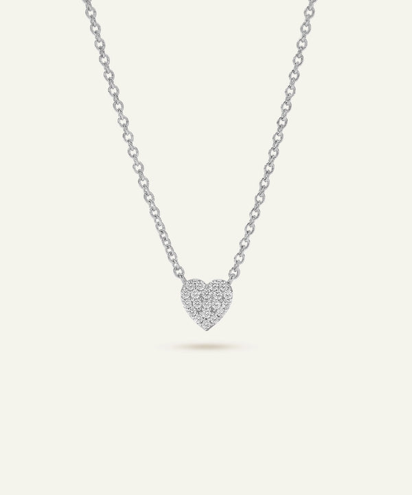 Silver heart-shaped pendant necklace on a light gray background