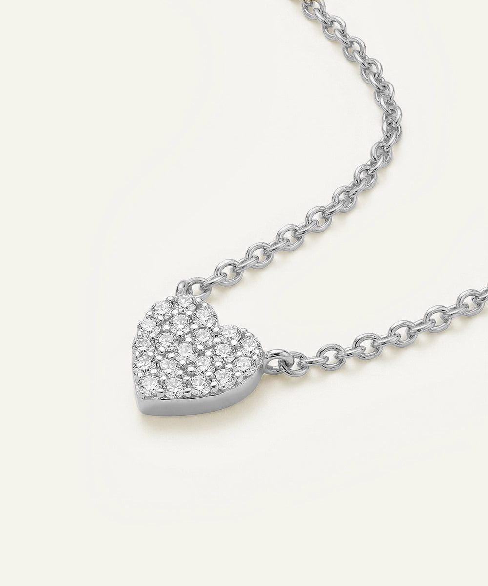 Silver heart-shaped pendant necklace on a white background