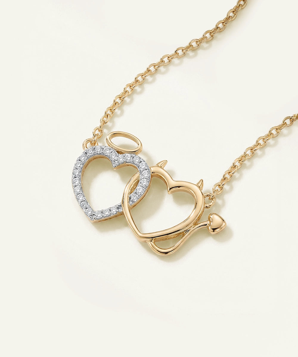 Gold necklace with heart-shaped pendant on a light beige background