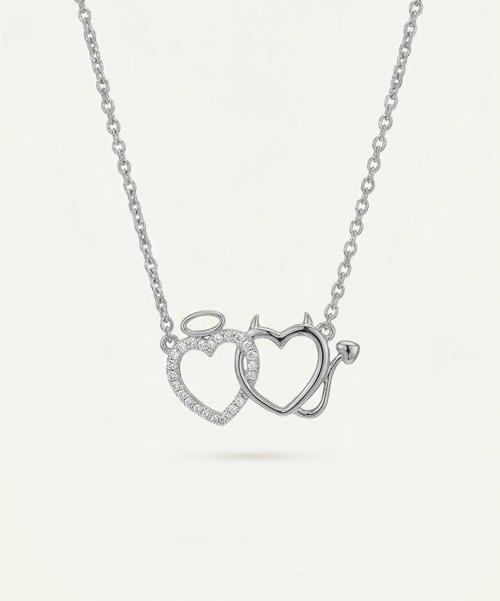 Silver necklace with interlocking heart pendants on a white background
