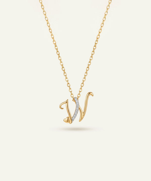 Gold necklace with a 'V' pendant on a light beige background