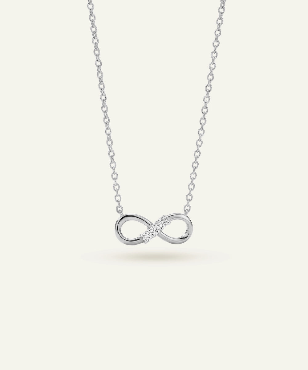 Silver infinity necklace on a white background