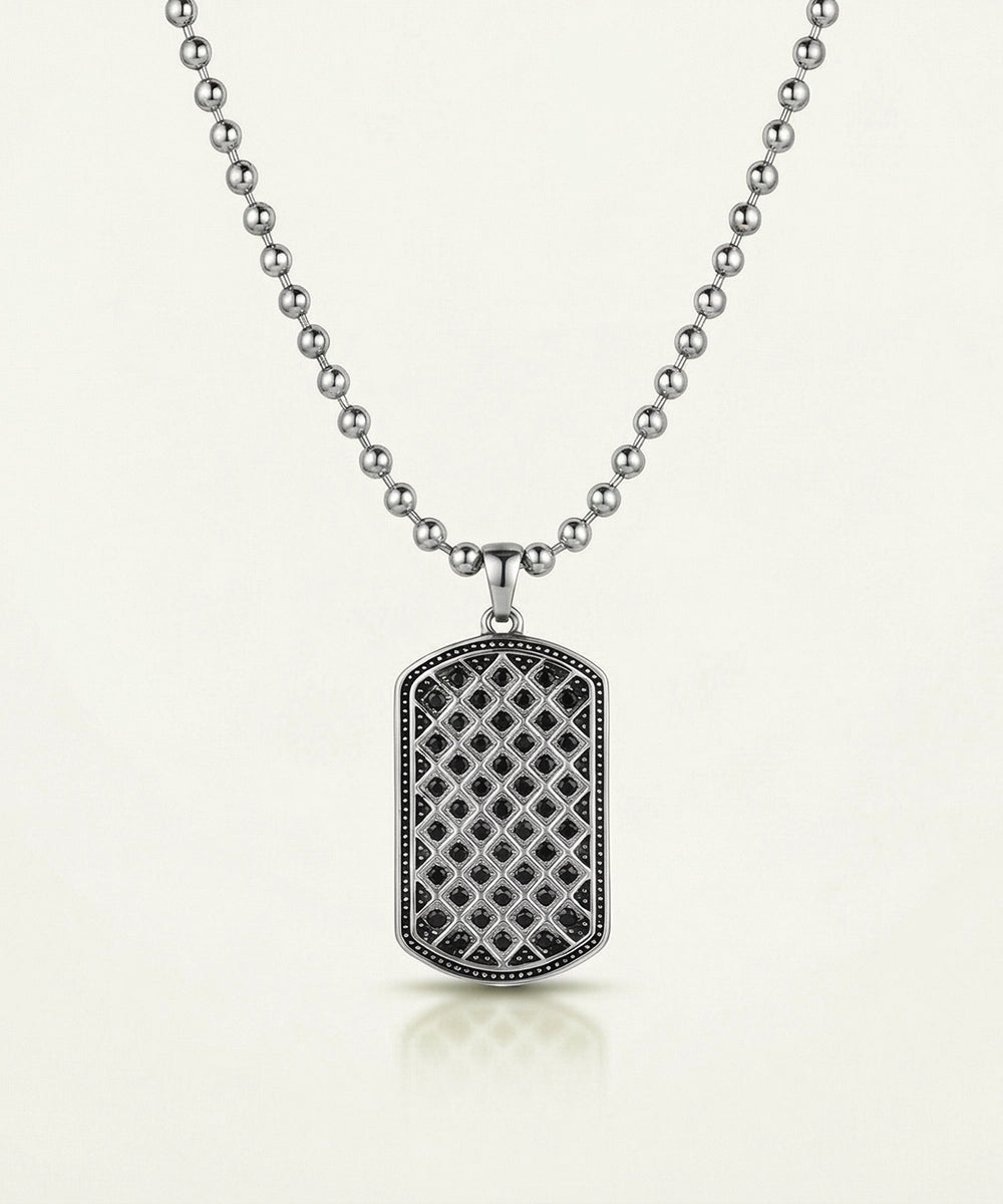 Silver necklace with a detailed pendant on a white background