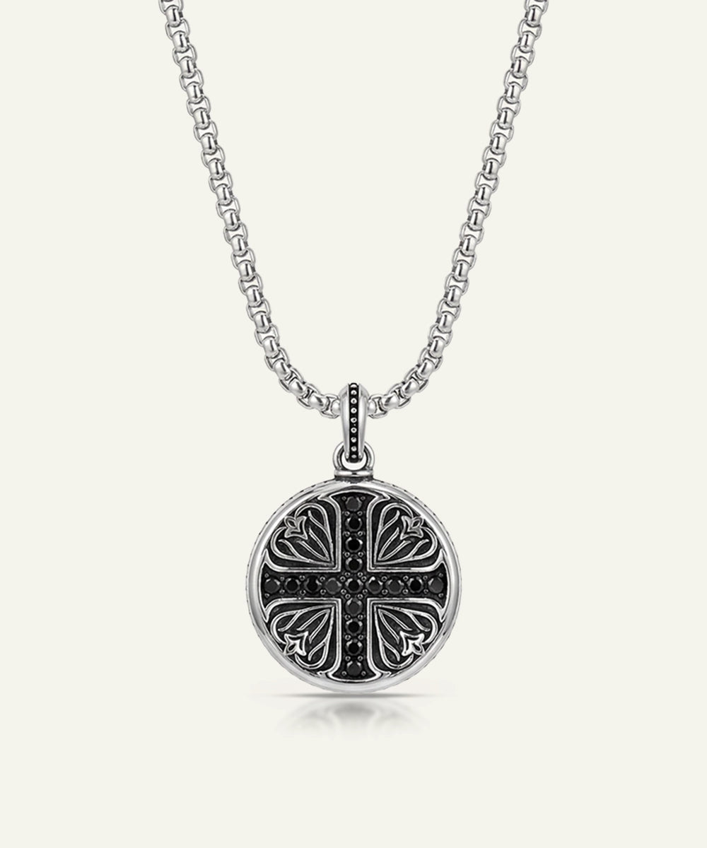 Silver necklace with a decorative pendant on a white background