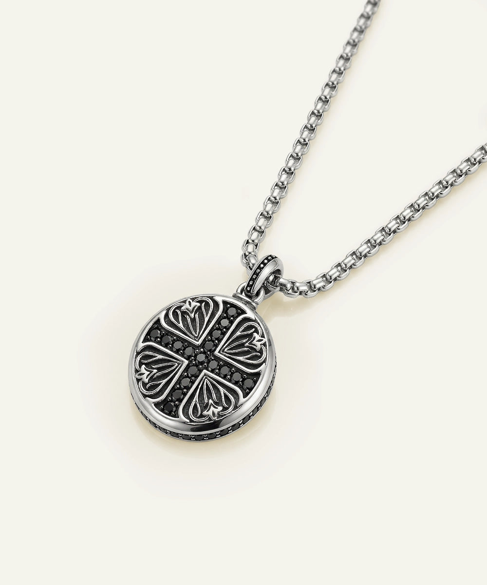 Silver necklace with a round pendant on a white background