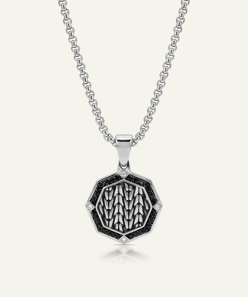 Silver necklace with a hexagonal pendant on a white background