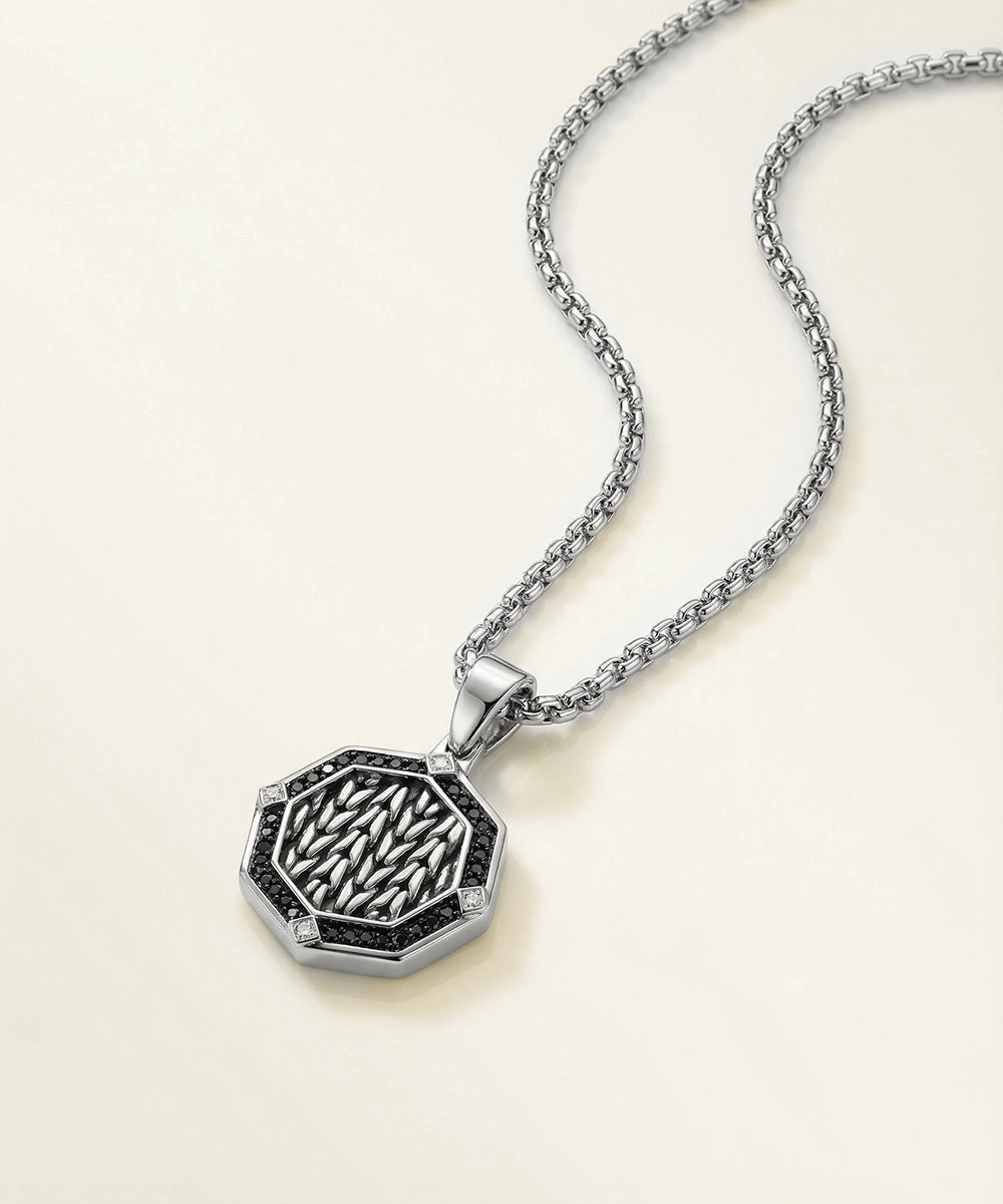 Silver necklace with a detailed pendant on a light beige background