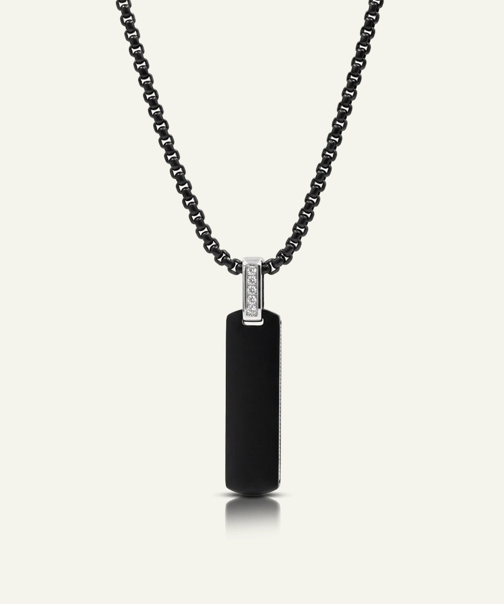Black pendant necklace with a diamond on a white background