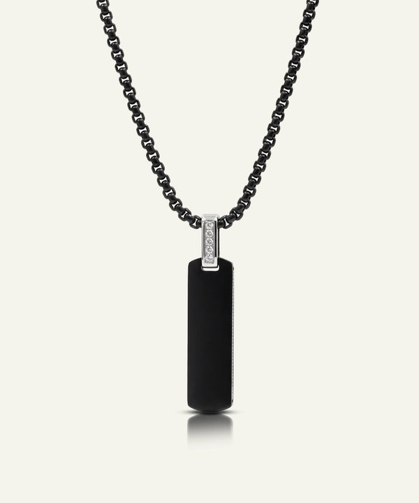 Black pendant necklace with a diamond on a white background