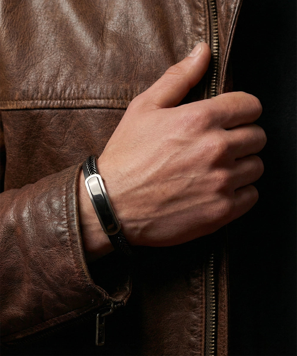 Hand wearing a smartwatch on a brown leather jacket