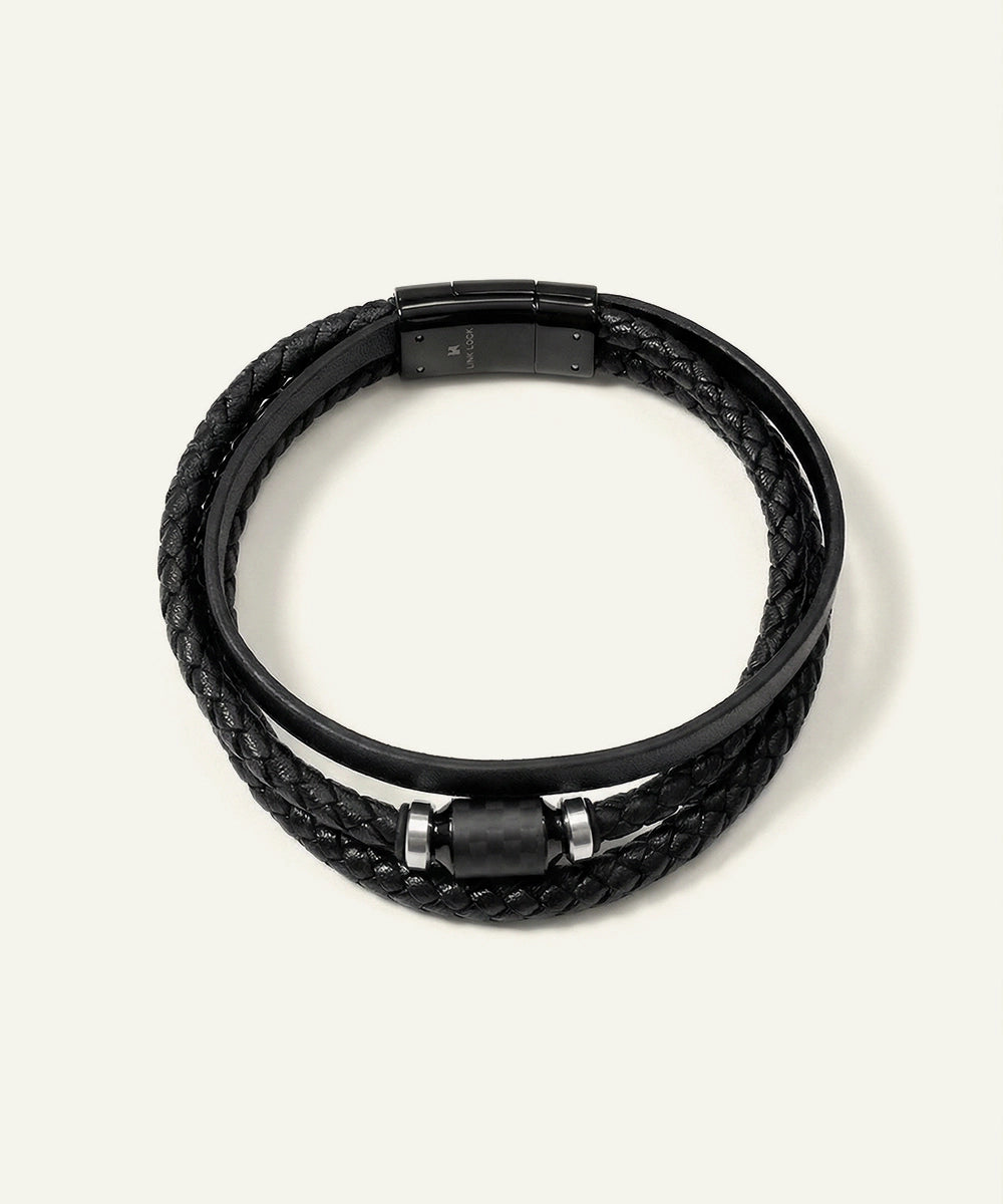 Black braided leather bracelet with metal clasps on a white background