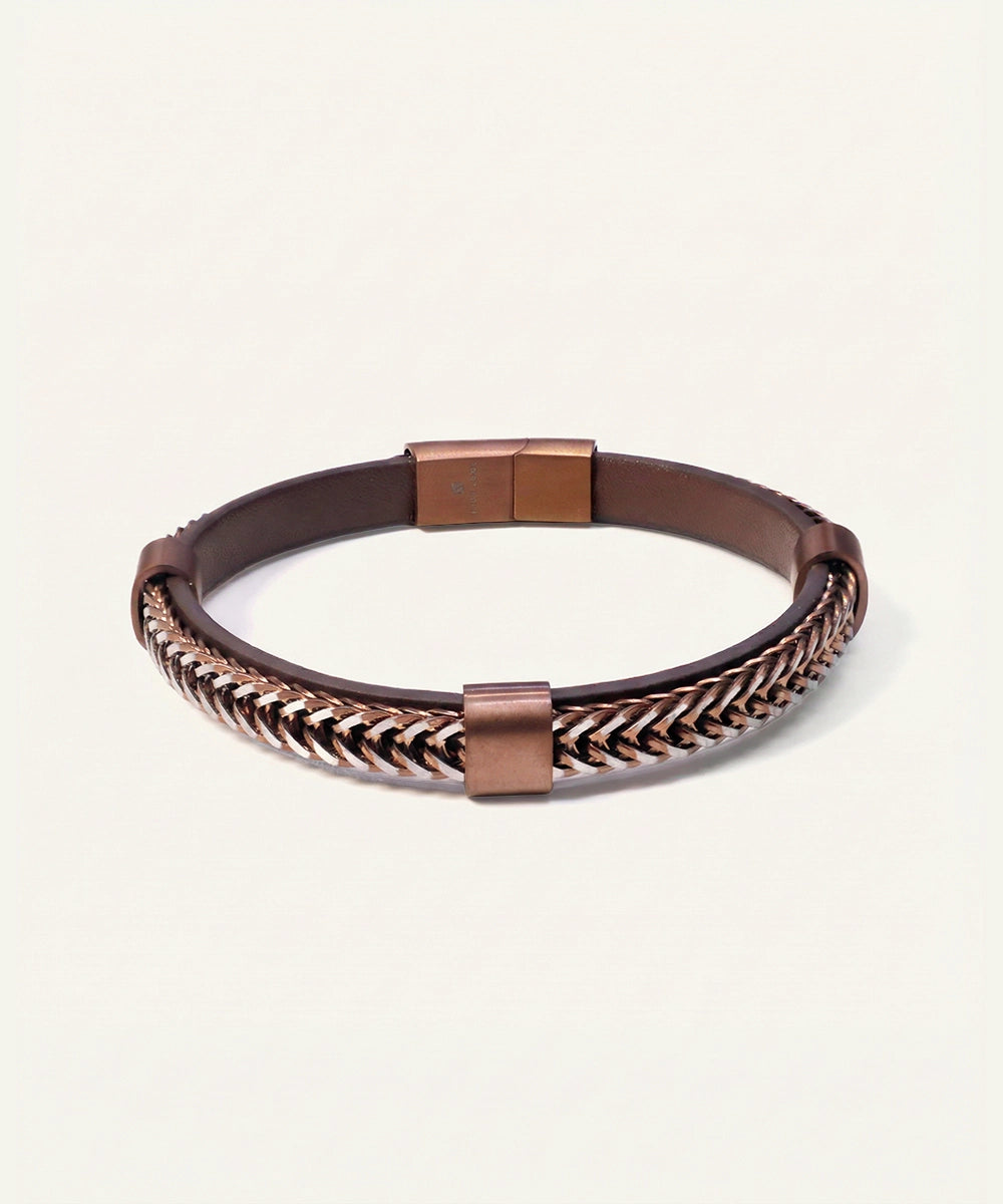 Bracelet with braided design and metallic clasp on a light background