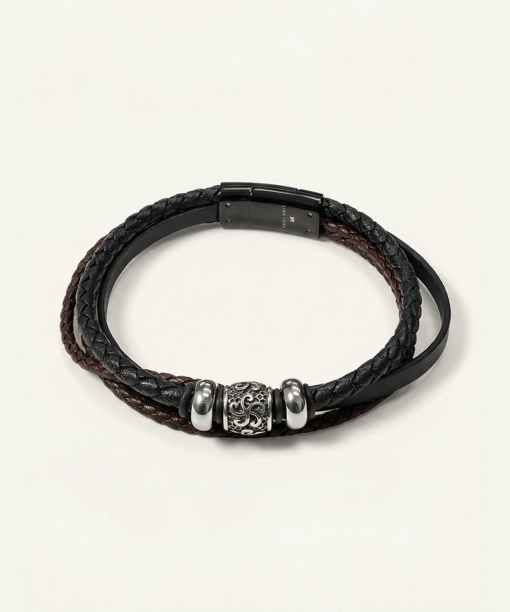 Black braided leather bracelet with silver beads on a white background