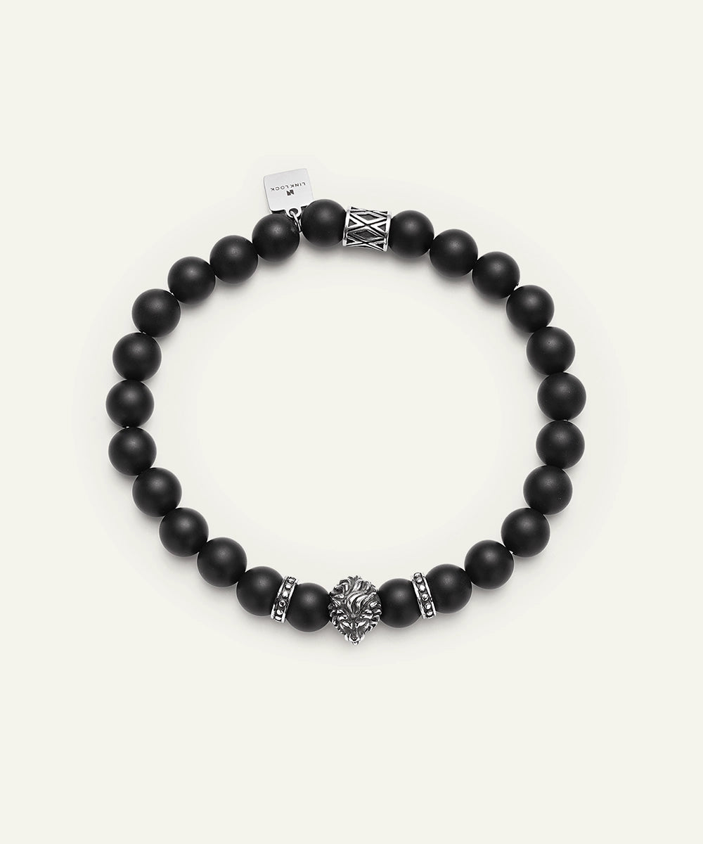 Black beaded bracelet with silver accents on a white background