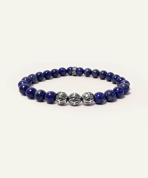 Blue beaded bracelet with silver clasp on a white background